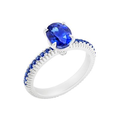 Fabergé Sapphire White Gold Fluted Ring features an oval blue sapphire centre stone, with pavé-set white diamonds, set in 18 karat fluted white gold. 