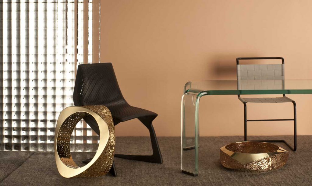 PVZ Neonero. “Pizzo d’Oro” Collection by NeoNero. Slave Bangles in 18kt rose and yellow gold.  "Myto" chair by Plank and "Stuhl W1" chair by Vitra Design Museum. "Ragno" table by Fiam