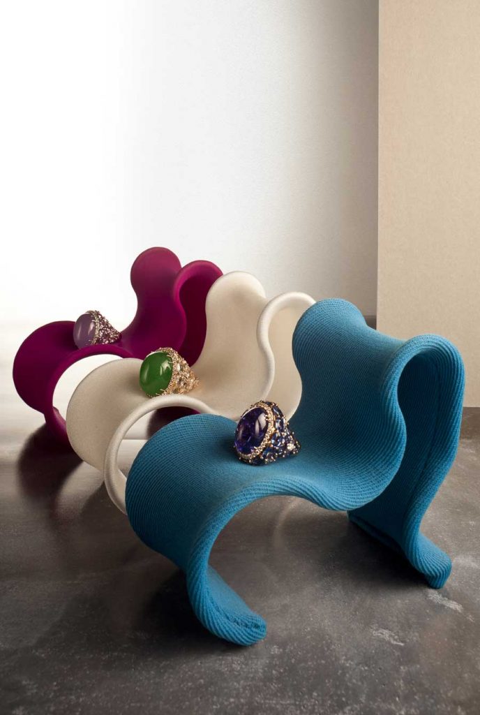 Piero Milano.  Rings in 18kt gold with green jade, violet and Tanzanite with colored sapphires and diamonds. "Fiocco" chairs by Busnelli