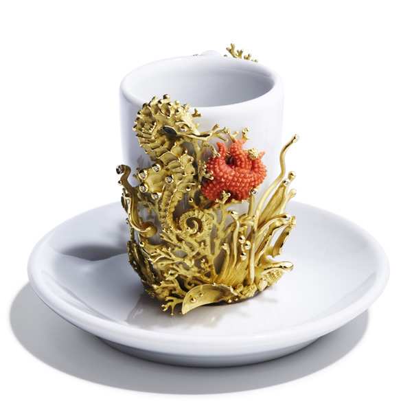 Above, a one-of-a-kind coffee cup adorned with a yellow 18kt gold sea-life motif of seahorse and algae, a starfish engraved in natural coral, and white diamonds.