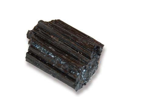 Black tourmaline specimen isolated on white background.