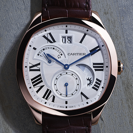 Drive de Cartier Second Time Zone Day/Night watch, Manufacture self-winding mechanical movement, caliber 1904 MC. 18K pink gold case, length: 40 mm, width: 41 mm, thickness: 12.63 mm, octagonal 18K pink gold crown set with a faceted sapphire. Silvered flinqué dial, Roman numerals, blued-steel sword-shaped hands. Sapphire crystal. Semi-matte brown alligator skin strap, 18 mm 18K pink gold double adjustable folding buckle. Large date at 12 o’clock, retrograde second time zone at 10 o’clock, day/night indicator at half past three, small seconds at 6 o’clock, sapphire case back. Water-resistant to 3 bar.