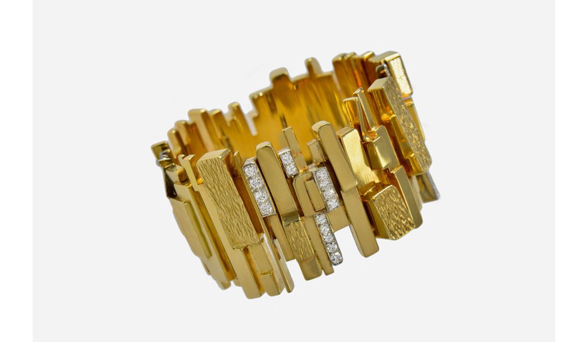 A diamond and textured and polished gold and platinum wide bracelet by David Morris, c. 1965
