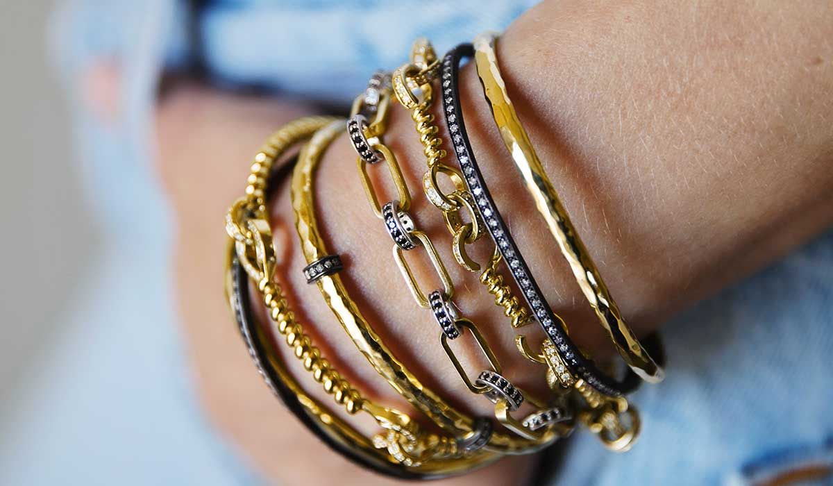 Chain bracelets and bangles in gold or oxidized silver with diamonds, Nancy Newberg. 