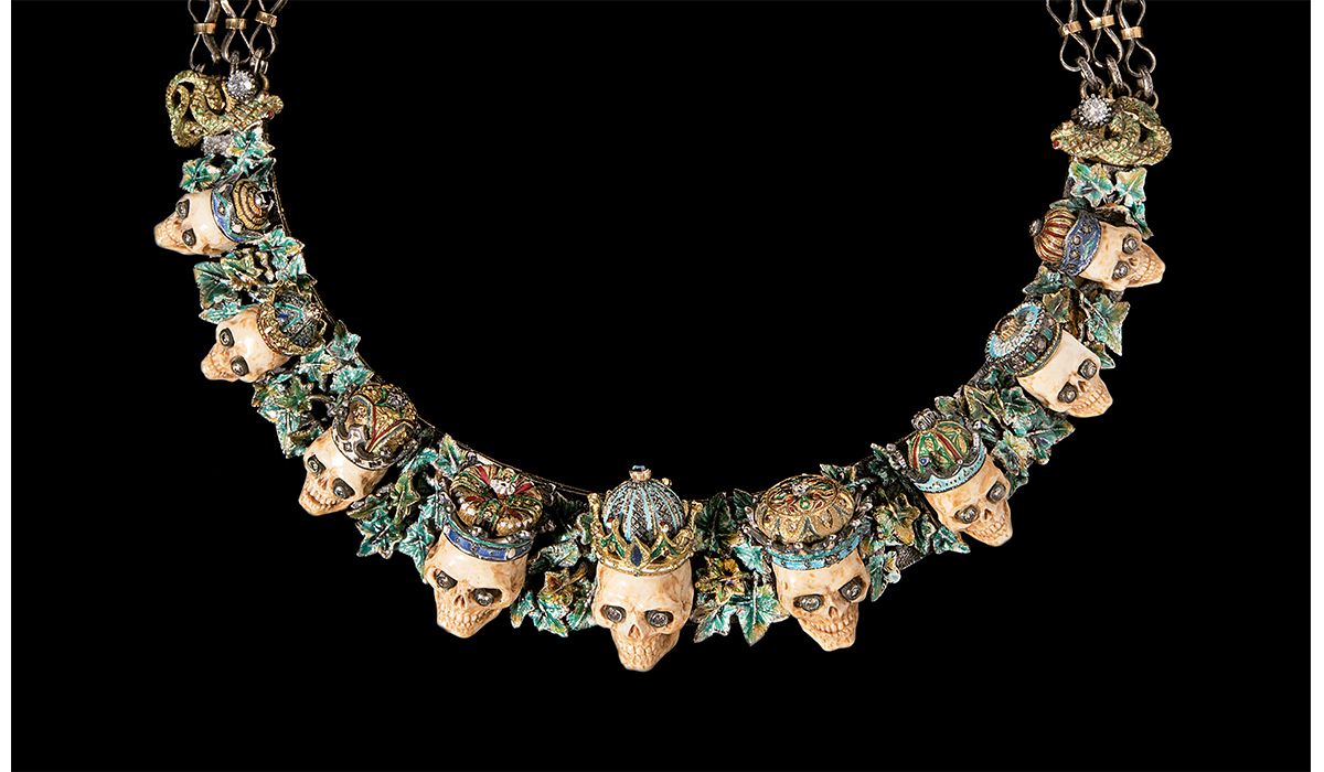 Skulls necklace in yellow gold, silver and polychrome enamel set with diamonds and semiprecious stones. Skulls of carved mammoth ivory, eyes set with diamonds, circa 1970s.