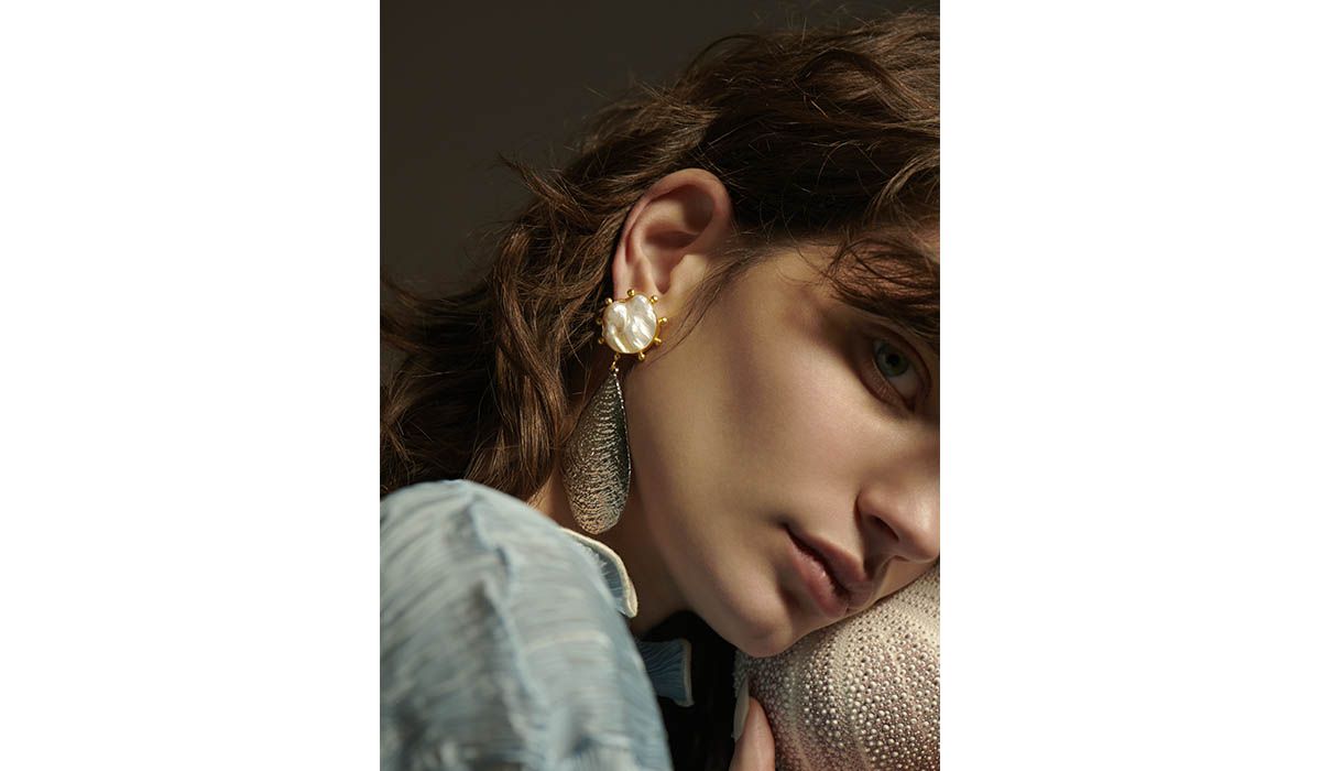 Gold plated brass and silver Sova earrings with baroque pearl, Peet Dullaert. Shirt, Peet Dullaert.