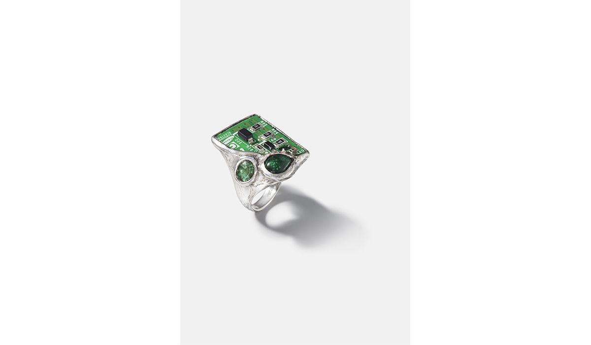 Silver and emeralds Circuit ring with a fragment of a mobile phone circuit board.