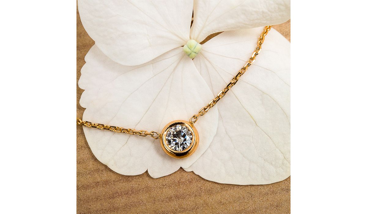 Ethic rose gold and moissanite necklace.
