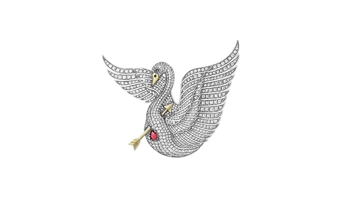 Swan King brooch, in gold and silver with colorless topazes and a ruby.