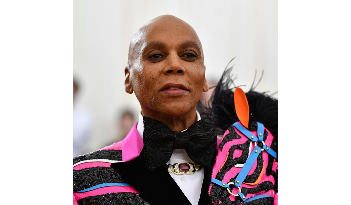 RuPaul wearing a gold diamond, black enamel necklace by David Webb